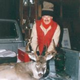Whitetail buck in bed of hunter's truck